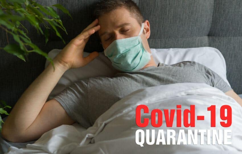 Sick man with medical mask lying in bed during Corona virus quarantine.