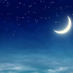 sleepy crescent moon in a starry night sky above soft clouds